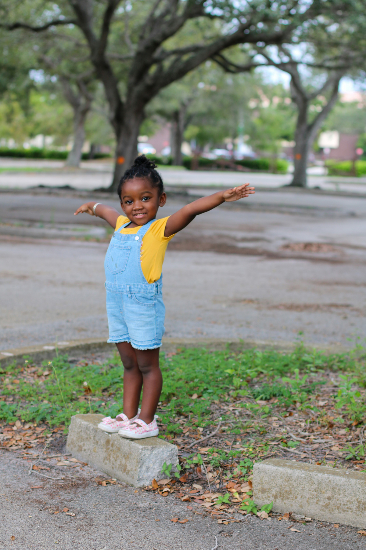 smiling child with arms lifted